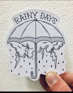 someone holding up a sticker that says rainy days