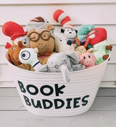 a bucket filled with stuffed animals sitting on top of a porch