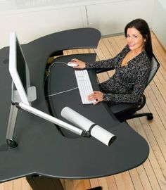 a woman sitting at a desk using a computer