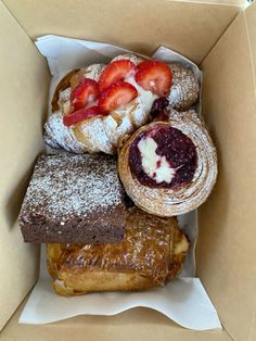 a box filled with pastries and strawberries on top of eachother's wrapper