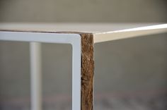 a close up view of a wooden table with white metal frame and wood slats