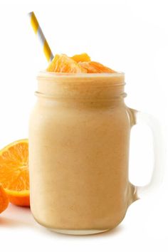 an orange smoothie in a mason jar with a straw