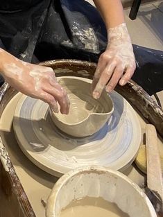 a woman is making pottery on a potter's wheel