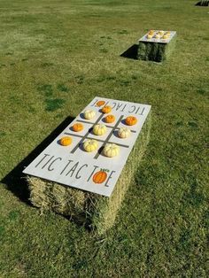 pumpkins are arranged on top of hay in the middle of a field with an advertisement for