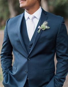 a man in a blue suit and white shirt