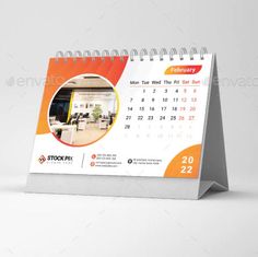 a desk calendar with an orange and white background