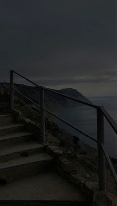 stairs leading down to the ocean at night