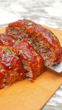 meatloaf with marinara sauce and parsley on cutting board