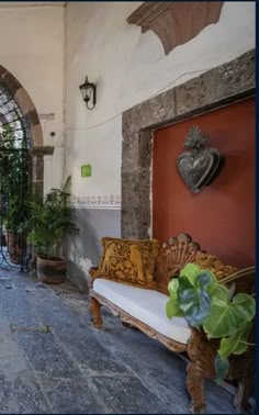 an arched doorway leads into a courtyard with potted plants