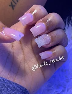 a woman's hand with some pink and white nail polishes on her nails