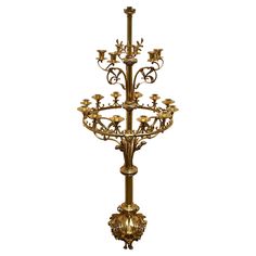 an ornately decorated candle stand with candles on it's sides and four lights in the middle