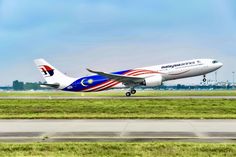 an airplane is taking off from the runway on a clear, blue day with green grass