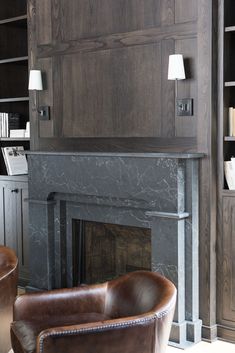 a living room filled with furniture and a fire place in front of a book shelf