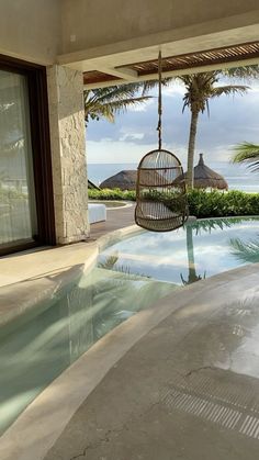 a pool with a hammock hanging from the ceiling