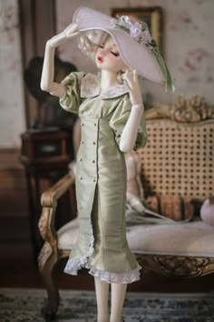 a doll wearing a green dress and hat