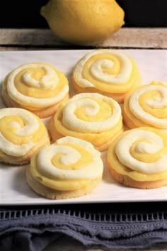 lemon cookies with icing on a plate next to a lemon