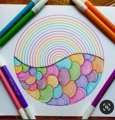 colored pencils and crayons on top of a paper with an image of a bowl