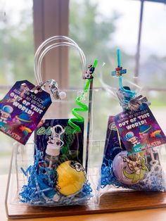 two clear bags filled with toys on top of a wooden table