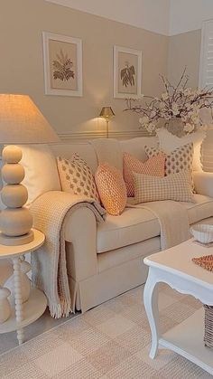 a living room filled with furniture and a lamp on top of a white coffee table