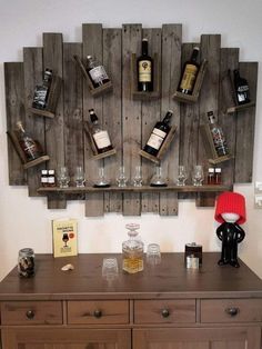 a wooden shelf with wine bottles and glasses on it