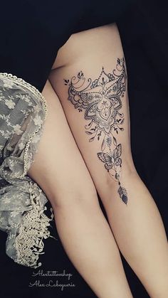 two women's legs with tattoos on them