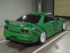 a green car parked in a parking garage