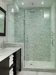 a bathroom with two sinks and a walk in shower