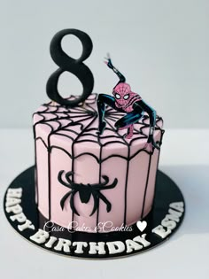 a spiderman birthday cake with the number eight on it's top and black icing