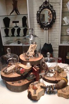 there are many different items on display in the glass case at this table, including jewelry and bracelets