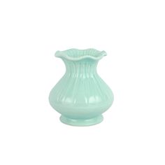 a light green vase sitting on top of a white table