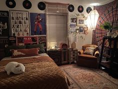 a bed room with a neatly made bed and lots of pictures on the wall above it