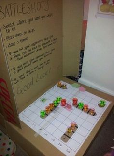 a board game with dices sitting on it's side in front of a sign