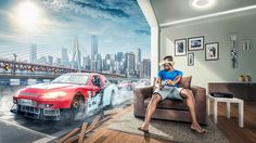 a man sitting on a couch in front of a wall mural with cars driving down the road