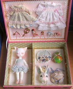 an open box with two dolls in it