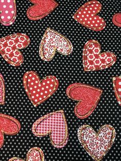 the fabric has hearts on it and polka dots in red, white, and black