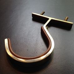 a close up of a metal object on a table with a black surface behind it