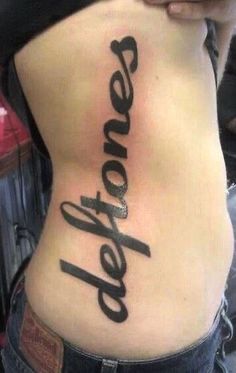 a woman's lower back with the word love written on it and her name in cursive font