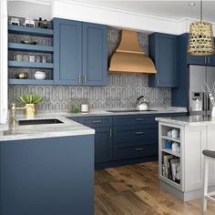 a kitchen with blue cabinets and white counter tops