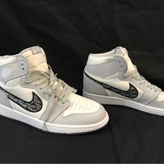 Elevate Your Sneaker Game With These Nike Dior Air Jordan 1 High Tops, Part Of The Limited Edition 2020 Release. With A Sleek White Color And High Top Style, These Athletic Shoes Are Perfect For Any Casual Or Sporty Occasion. The Shoe Features A Uk Shoe Size Of 9, Us Shoe Size Of 10, And Eu Shoe Size Of 37.5, Ensuring A Comfortable Fit For Any Foot. These Air Jordan 1s Are Made With High-Quality Materials And Crafted With Precision To Ensure Durability And Longevity. They Are A Must-Have For Any Luxury High-top Jordan Shoes, Designer High-top Jordan Shoes With Branded Insole, Designer Low-top Jordan Shoes, Jordan 1 High Top, Air Dior, Air Jordan 1s, Preppy Shoes, Jordan 1s, Sneaker Games