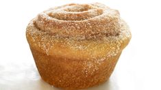 a powdered sugar covered muffin sitting on top of a white surface