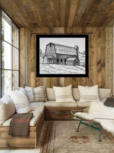 a living room filled with lots of furniture and pillows on top of a wooden floor