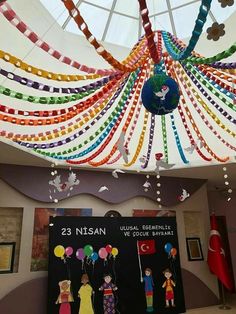 the ceiling is decorated with colorful streamers and balloons for children's birthdays