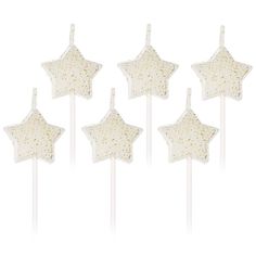 six white star shaped lollipops with gold sprinkles on them