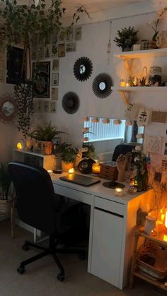 a home office with plants and candles on the desk