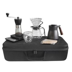 an assortment of coffee and espresso equipment on a black case