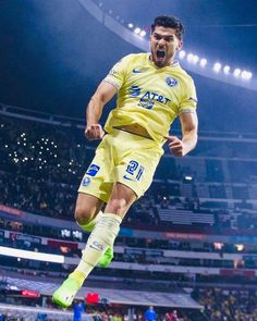 a soccer player is jumping in the air with his mouth wide open and eyes closed