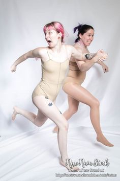 two young women in leotards are posing for a studio photo with white background