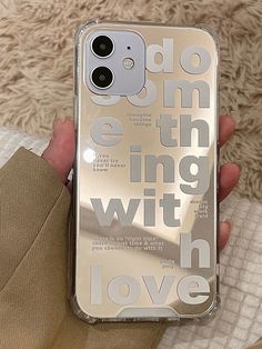 someone is holding up their phone case with the words love on it in white and silver