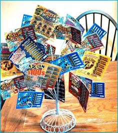 a table topped with lots of cards on top of a wooden table next to a chair