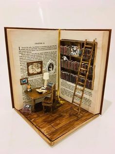 an open book with a miniature desk and ladder